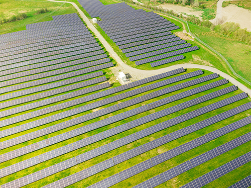 A green field with a large solar farm in it.